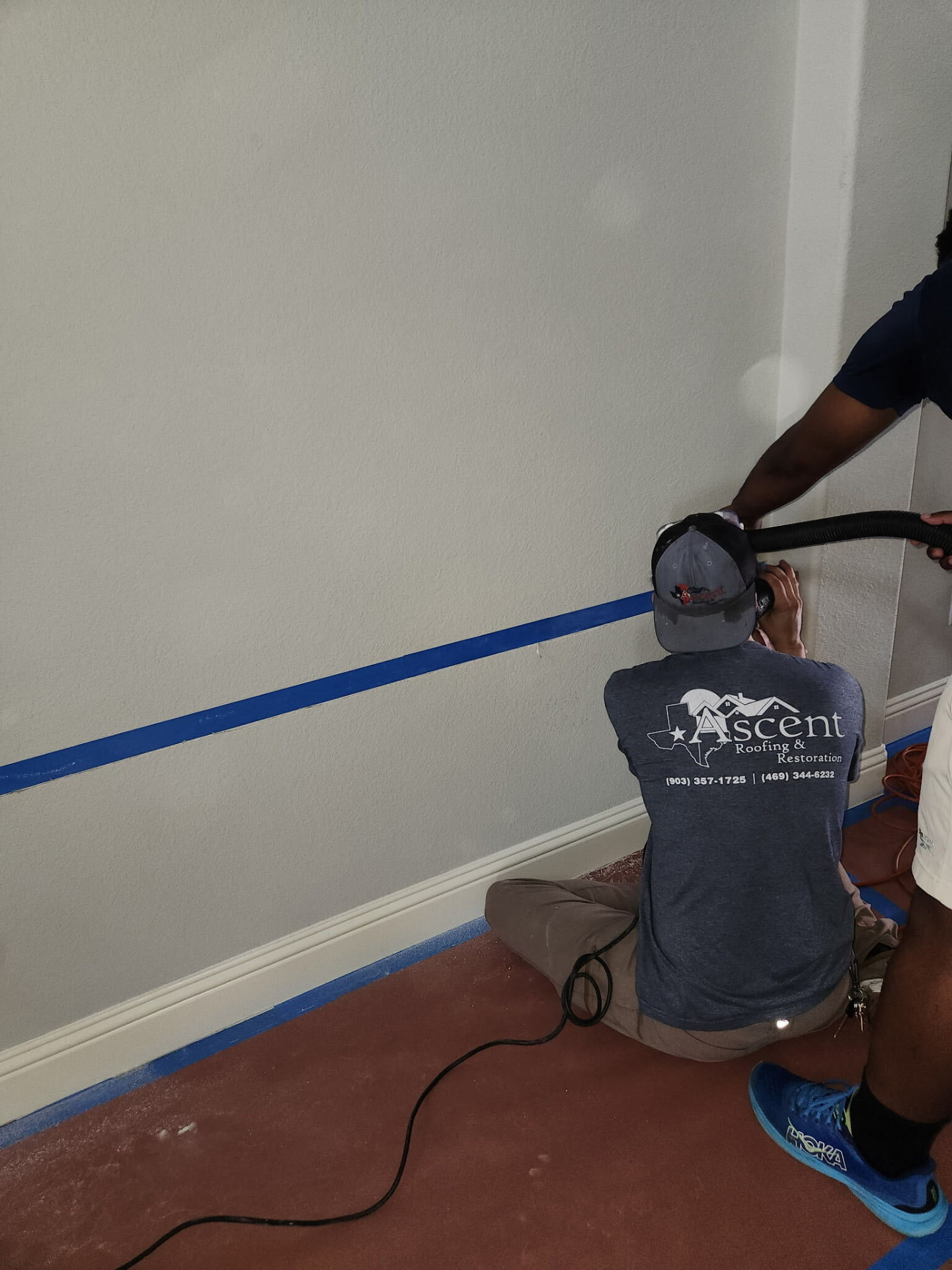Ascent crew working along a wall during an interior restoration